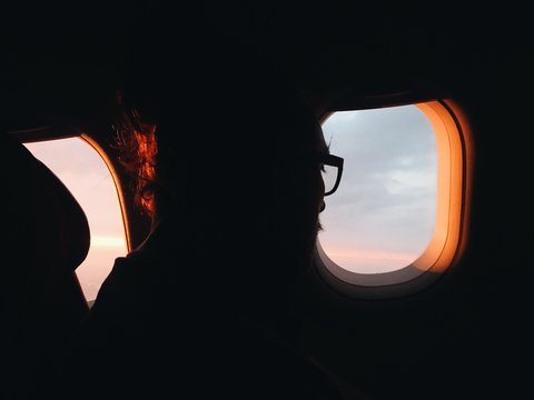 A man watching from airplane window