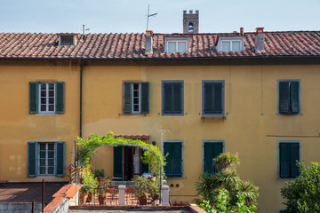 Fototapeta na wymiar Rooftop garden terrace as seen from a walk around the walls encircling the beautiful city of Lucca in Tuscany, Italy