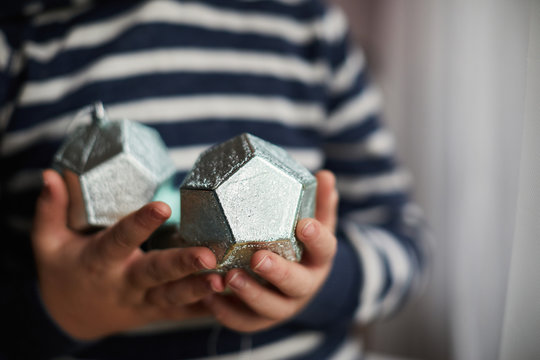Child holding Christmas decorations