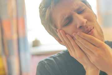 close up male head suffer from toothache f