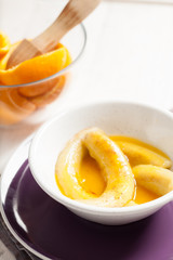 Fried bananas in orange sauce, a delicious dessert from fruits, butter and cognac.