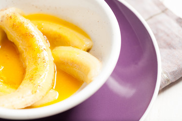 Fried bananas in orange sauce, a delicious dessert from fruits, butter and cognac.