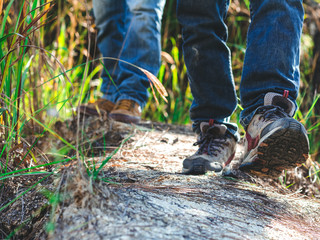 Close-up of two male hikers shoes walking on a mountain trail.