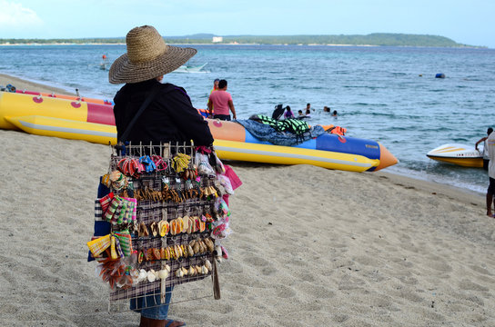 Laiya, San Juan, Batangas, Philippines - October 31, 2016: Lady street vendor selling tourist souvenirs at sea side resort
