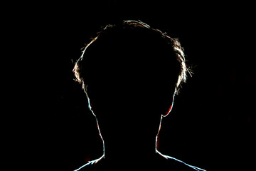silhouette of man head on dark black background with lighten circuit contour f