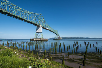 Astoria-Megler bridge, which goes over the Columbia River in Astoria Oregon. Dock pillars in foreground