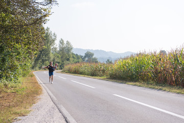 happy couple jogging along a country road