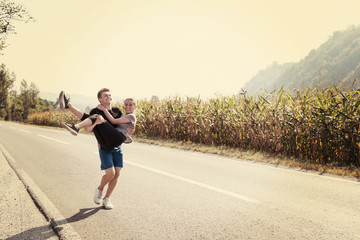 happy couple jogging along a country road