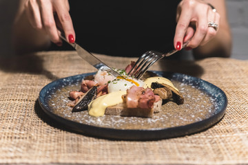 Woman in restaurant eating eggs