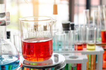 A pipette dropping sample into a test tube,abstract science background