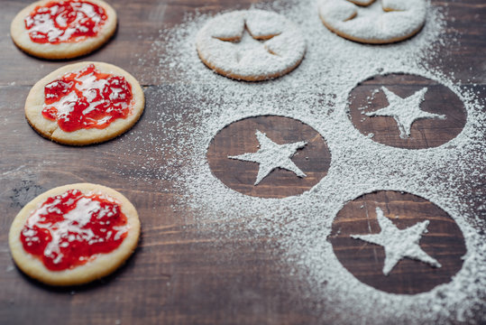 Shortbread cookies with jam and powedered sugar prints