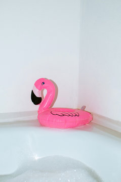 Pink flamingo toy in bathroom