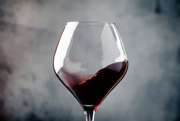 Spanish dry red wine, splash in glass, from the tempranillo grape, gray stone background, defocused in motion image, shallow depth of field