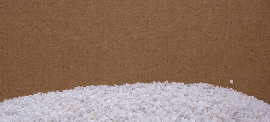 Small white stones scattered on a wooden background
