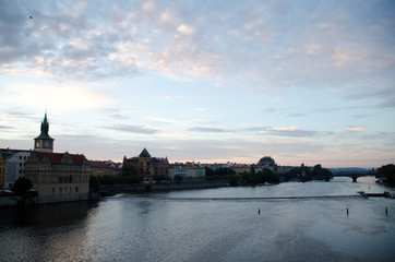 Fototapeta na wymiar Watching sunrise on Vltava from Charles bridge