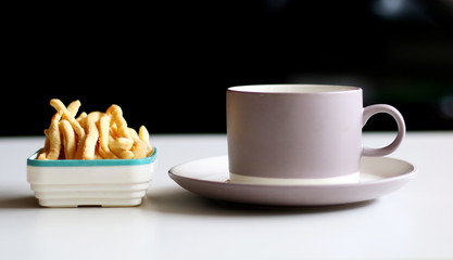 Cheese stick pastry and a cup of drink.