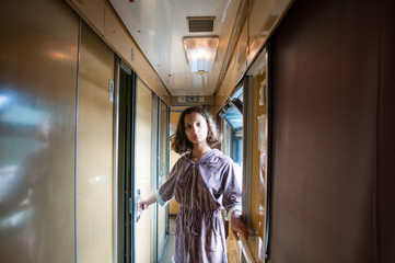 Girl comes into compartment from corridor of train, a trip in summer