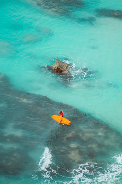 Woman surfing at wild tropical beach