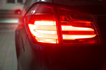 Detail of red metallized black rear car headlight 