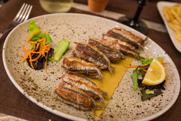 A plate of fried sardines served in a restaurant in Italy