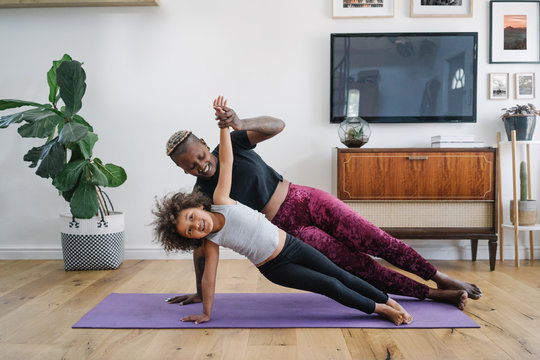 Mom and daughter doing yoga