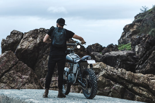 Young man on custom built motorbike