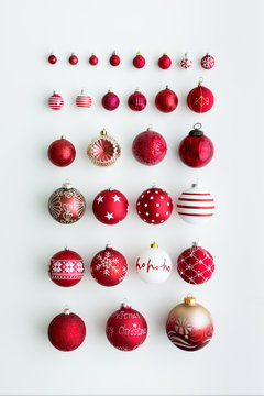 Red Christmas ornaments on white