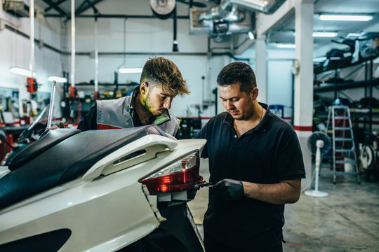 Mechanics working in the motorbike workshop