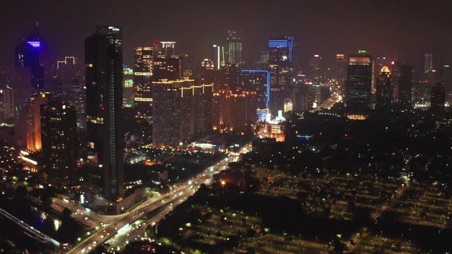 JAKARTA, Indonesia - November 06, 2018: Panoramic aerial landscape of Jakarta city at nighttime with night lights and skyscrapers. Shot in 4k resolution