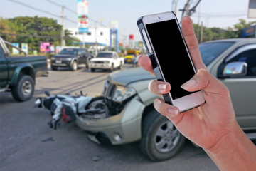 Man using smartphone at roadside after car accident and blurry background  with clipping path on screen panel