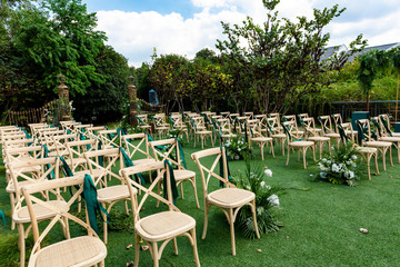 No one's outdoor wedding scene, green plants and neatly arranged chairs