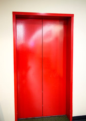 freshly painted red elevator doors
