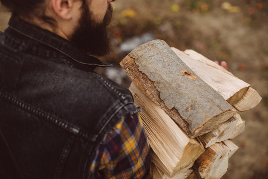 man carries wood pieces
