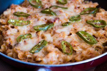 Homemade vegetarian baked paste in pan with cheesy tomato sauce