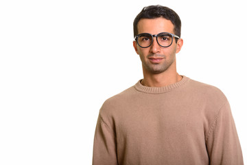 Portrait of young handsome Persian man with nerdy eyeglasses