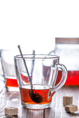 Concept - time to drink tea. Two cup of tea and teapot on wooden table.