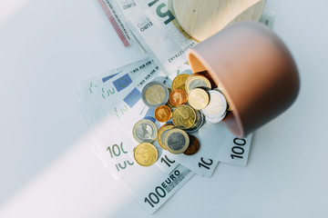 Paper currency notes and coins euros, white background