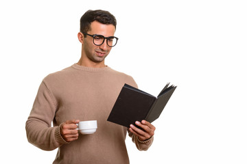 Portrait of young handsome Persian man reading diary or book