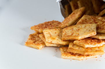 Flavoured biscuits spilling out of the packaging onto a white bench