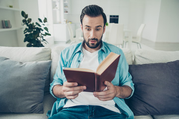 Good-looking good-wearing charming bearded man with staring eyes