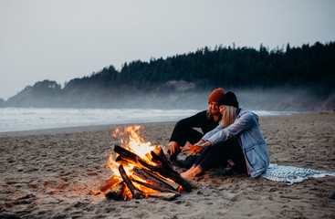 Beach bonfire and couple