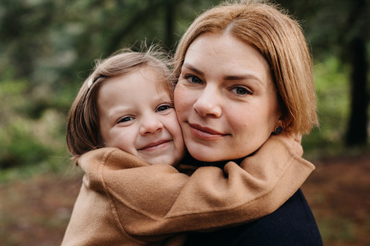 Daughter Sweetly Embracing Mother