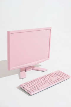 Pink PC and keyboard in white space