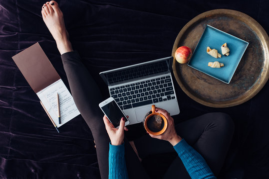 Woman at home checking he smart phone