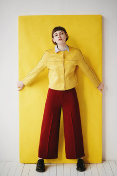 Direct view of girl in yellow jacket and maroon pants wearing
