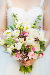 wedding bouquet in hands of bride