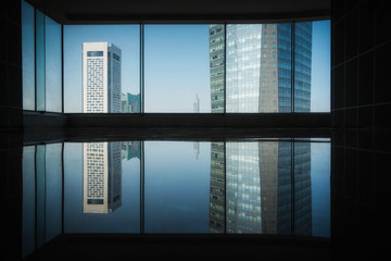 Reflections of tall buildings in front of Windows
