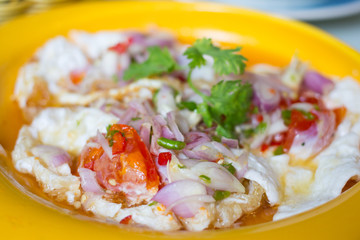 Spicy salted fried eggs with salad