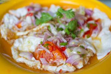 Spicy salted fried eggs with salad