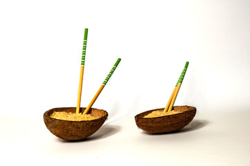 Rice in organic coconut bowl with chopsticks, close up,copy space, isolated